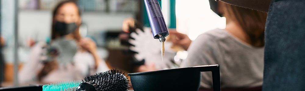 Close-up of hairdresser prepares color for hair dyeing at the salon.